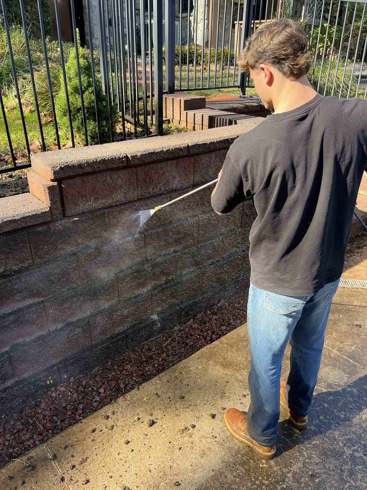Pressure washing a stone retaining wall in Lynchburg, VA
